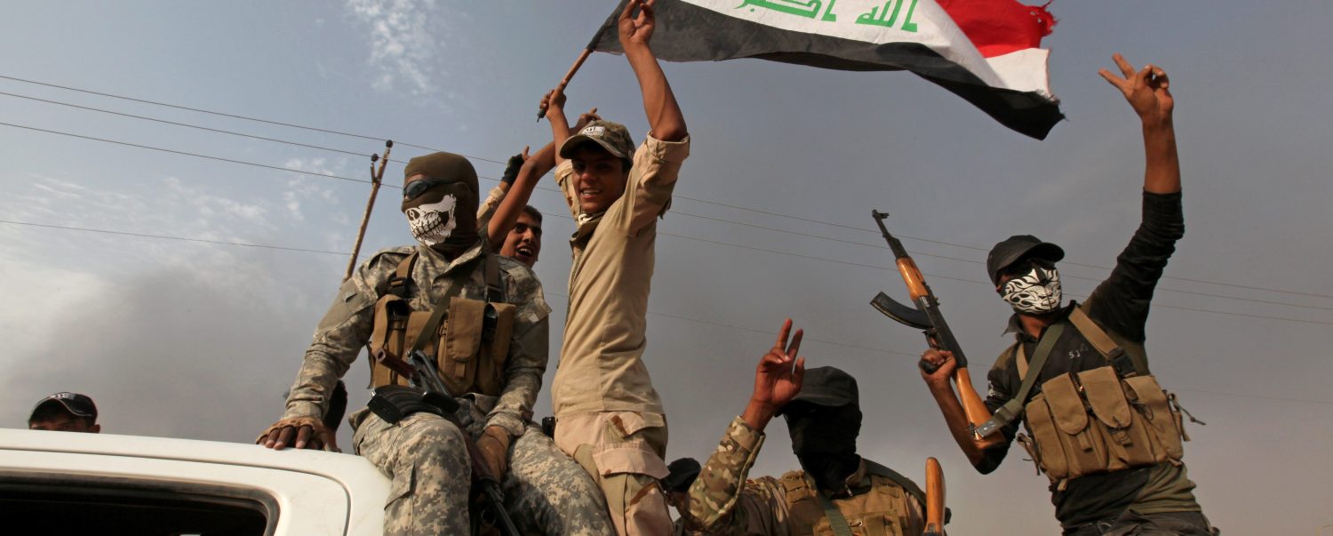Iraqi security forces gesture in Qayyara, Iraq.