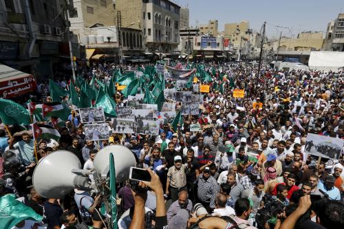 Protesters from the Islamic Action Front carry banners and flags as they take part in a demonstration in support of Palestinians and against the violence that occurred at al-Aqsa Mosque, after Friday prayers in Amman, Jordan July 31, 2015. Masked rock-throwing Palestinians and Israeli police using stun grenades clashed on Sunday at al-Aqsa mosque plaza, on the annual Jewish day of mourning for Jerusalem's two destroyed Biblical temples. REUTERS/Muhammad Hamed