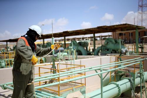 A worker maintains oil pipelines at the Zueitina oil terminal in Zueitina