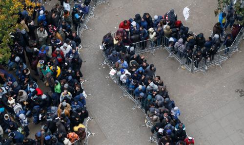Migrants queue in the compound outside the Berlin Office of Health and Social Affairs (LAGESO) as they wait to register in Berlin, Germany, October 7, 2015. German authorities are struggling to cope with the roughly 10,000 refugees arriving every day, many fleeing conflict in the Middle East. The government expects 800,000 or more people to arrive this year and media say it could be up to 1.5 million. REUTERS/Fabrizio Bensch
