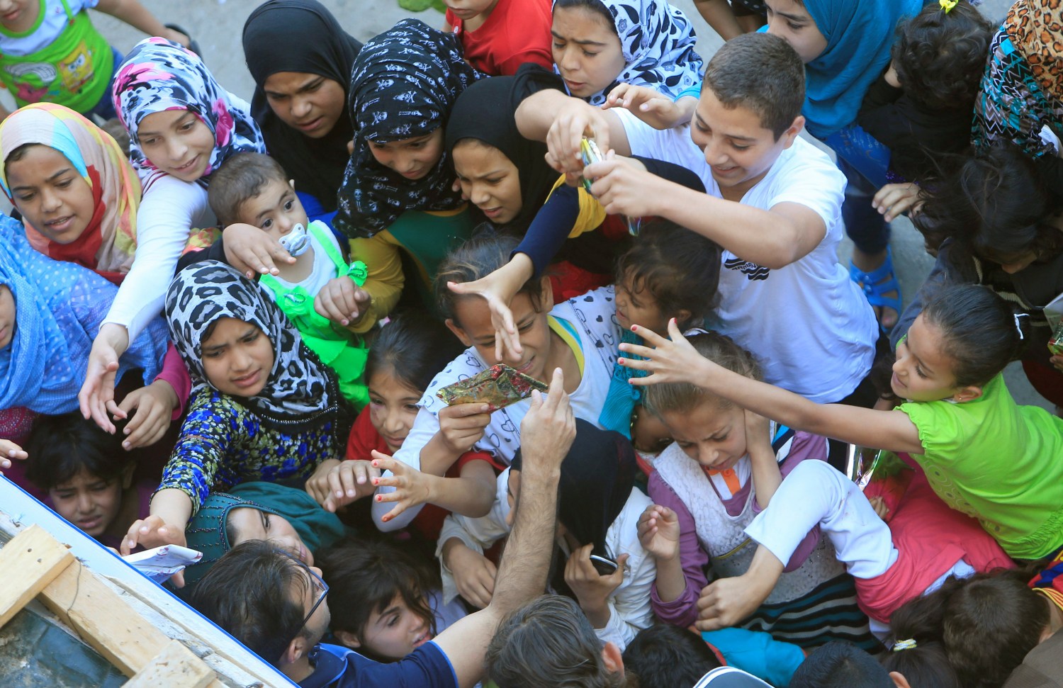 Syrian refugee children receive gifts in a housing compound in southern Lebanon.