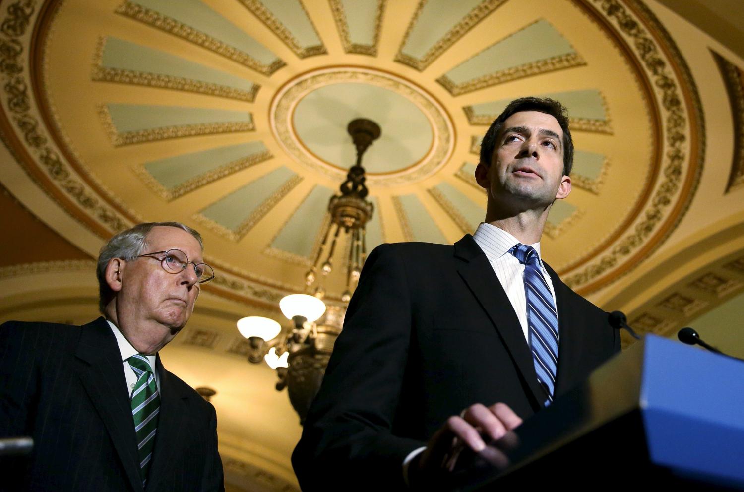 Senate Majority Leader Mitch McConnell (R-KY) (R) listens to fellow lawmaker Tom Cotton (R-AR) discuss the Military Construction and Veterans Affairs and Related Agencies Appropriations Act, 2016 on Capitol Hill in Washington October 1, 2015. REUTERS/Gary Cameron - RTS2N9Q