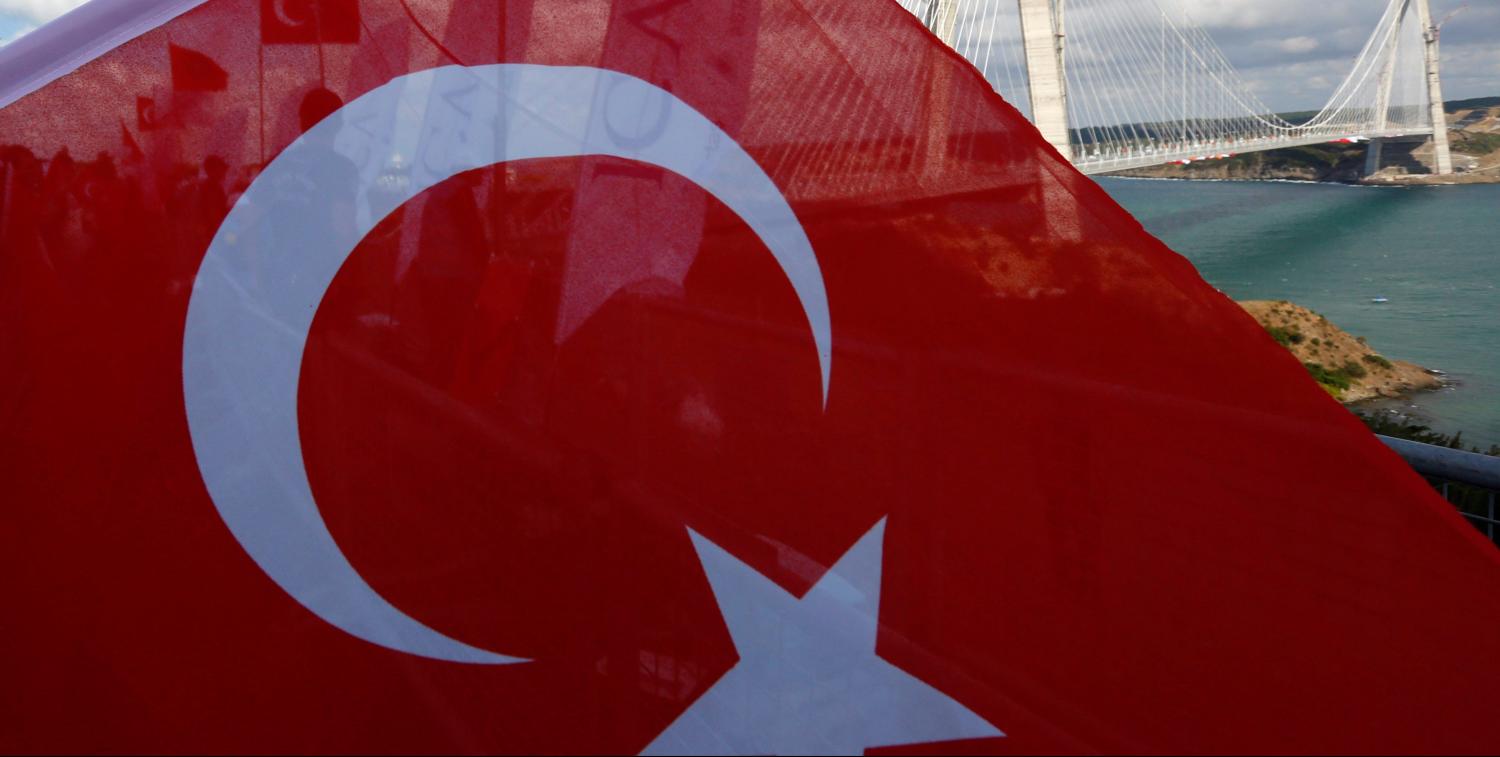 Newly built Yavuz Sultan Selim bridge, the third bridge over the Bosphorus linking the city's European and Asian sides is pictured with a Turkish flag during the opening ceremony in Istanbul, Turkey, August 26, 2016. REUTERS/Murad Sezer - RTX2N6BH