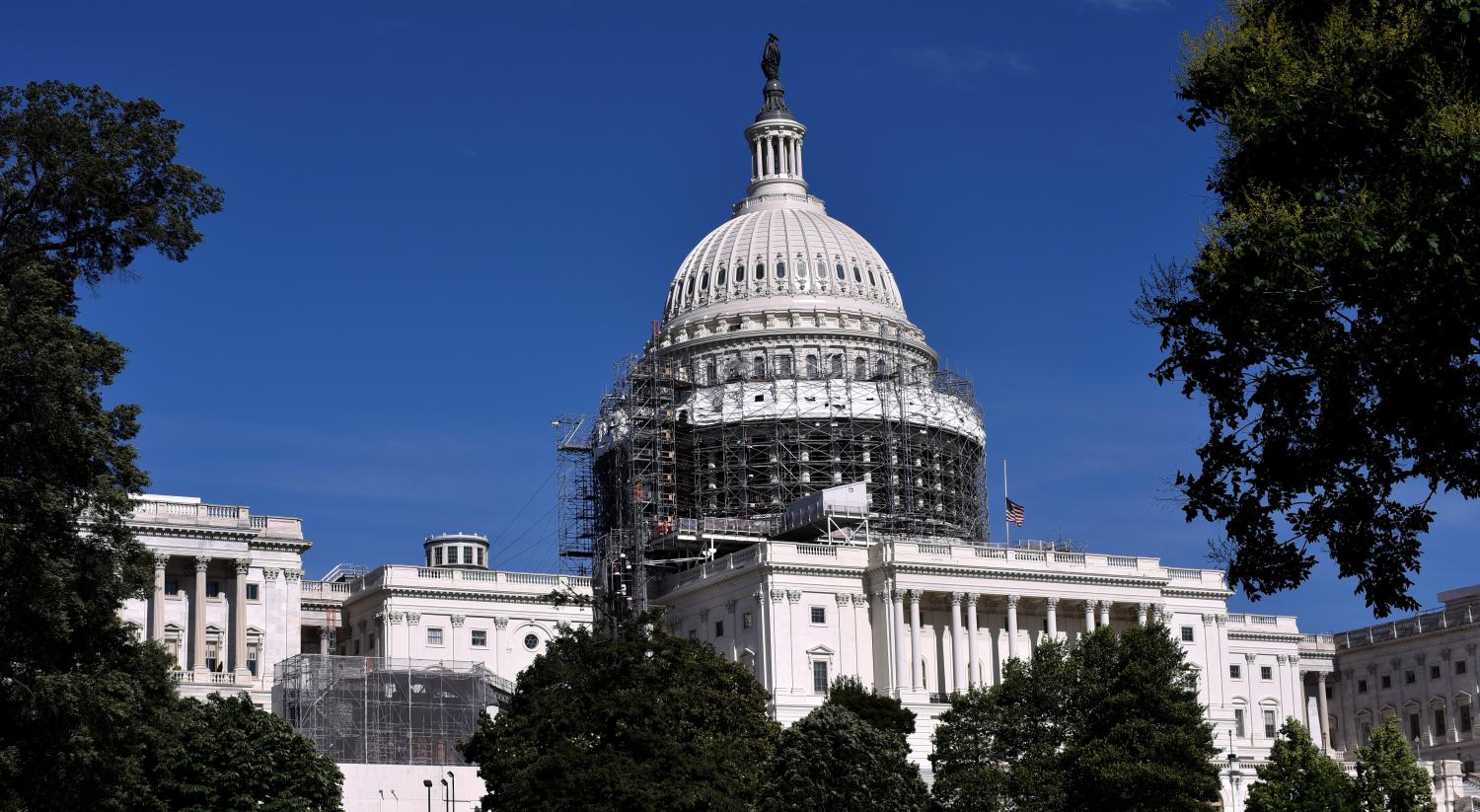 The U.S. flag flies at half-staff over the U.S. Capitol later in the day following the deadliest mass shooting in U.S. history at a gay nightclub in Orlando, Florida in Washington June 12, 2016. REUTERS/James Lawler Duggan - RTX2FU9H