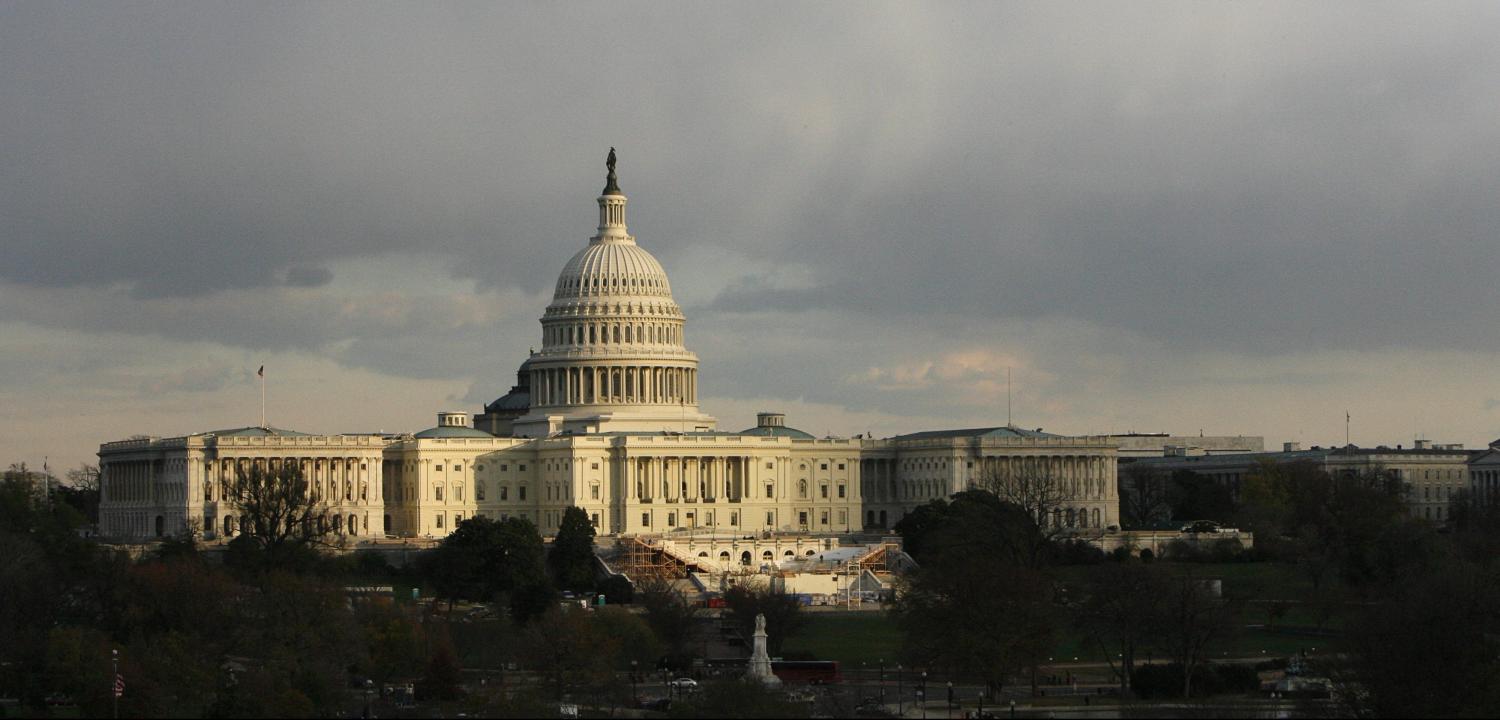 The U.S. Capitol building is seen as the sun begins to set under heavy cloud cover in Washington