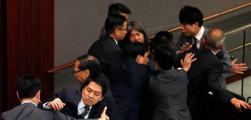 Pro-democracy lawmakers Ted Hui and Leung Kwok-hung are blocked by security guards as they try to stop the process of electing council chairman at the Legislative Council in Hong Kong, China October 12, 2016. REUTERS/Bobby Yip - RTSRWGQ