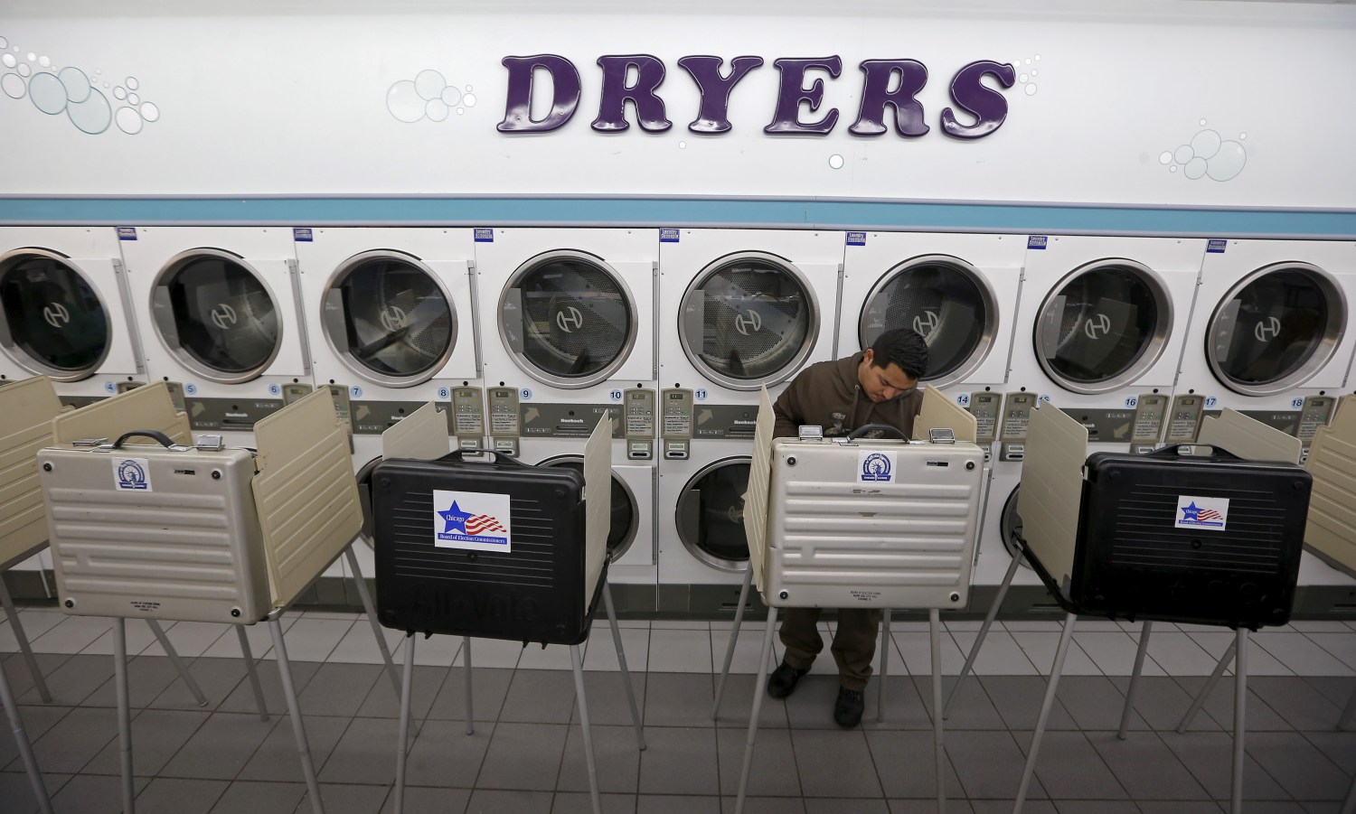 A voter casts a ballot at Su Nueva laundromat during voting in Illinois' U.S. presidential primary election in Chicago