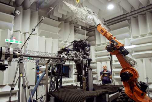 REUTERS/Alessandro Garofalo- A technician works on a Multiair engine in the anechoic room at the Fiat Powertrain Technologies research center in Orbassano, near Turin July 23, 2009.