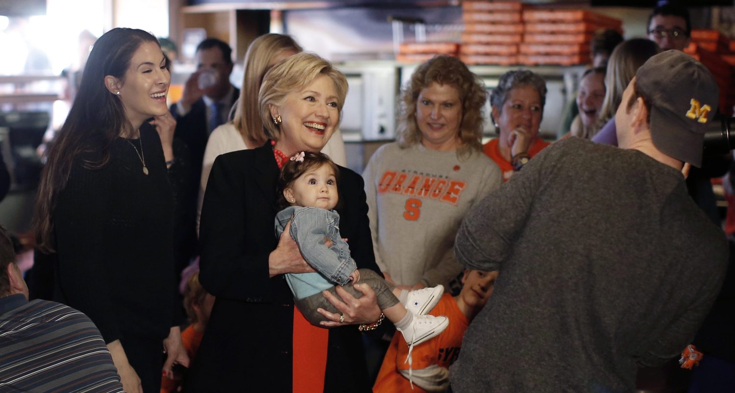 U.S. Democratic presidential candidate Hillary Clinton holds a baby during a campaign stop at Varsity Pizza in Syracuse.