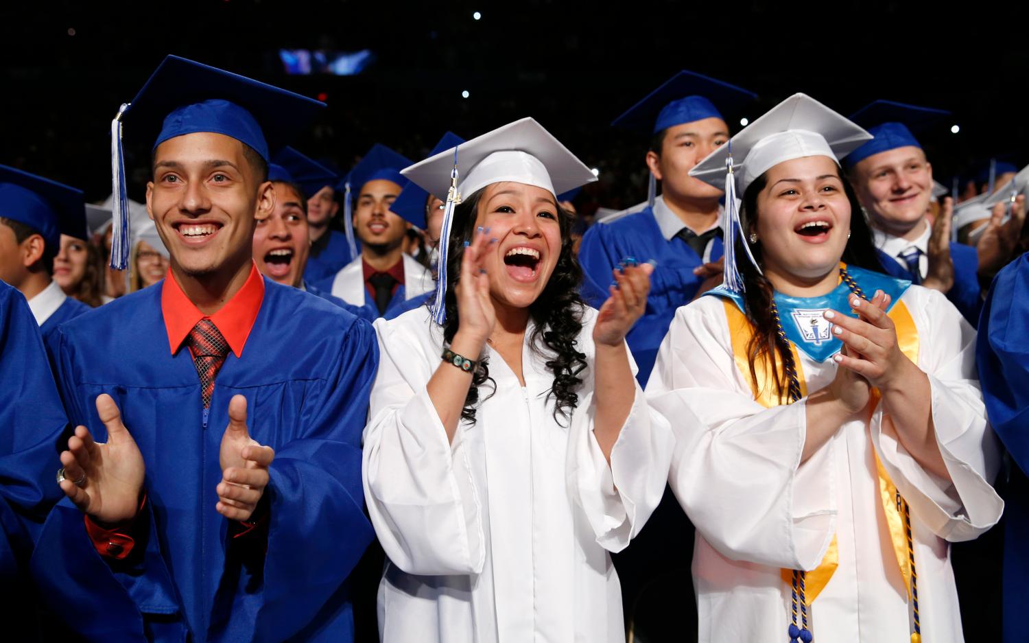 Students applaud as U.S. President Obama arrives to deliver the commencement address at the Worcester Technical High School graduation ceremony in Worcester