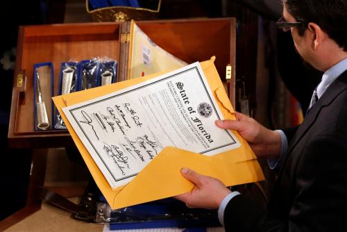A man holds the State of Florida electoral certificate during the vote tally in Congress in 2012.