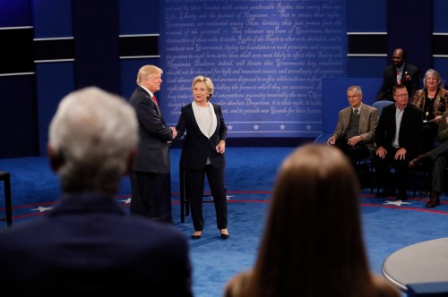 Former U.S. President Bill Clinton (L) and daughter Chelsea (R) watch as Republican U.S. presidential nominee Donald Trump and Democratic nominee Hillary Clinton shake hands at the conclusion of their presidential town hall debate at Washington University in St. Louis, Missouri, U.S., October 9, 2016. REUTERS/Shannon Stapleton - RTSRJ97