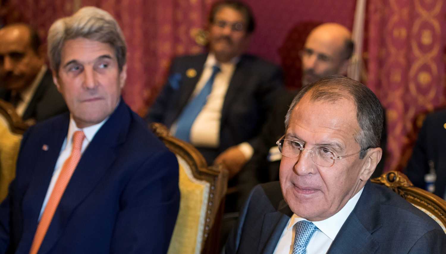Russia's Foreign Minister Sergei Lavrov (L) and U.S. Secretary of State John Kerry (R) react around a table during a bilateral meeting where they discussed the crisis in Syria, in Lausanne, Switzerland, October 15, 2016. REUTERS/Jean-Christophe Bott/Pool - RTX2OYRS