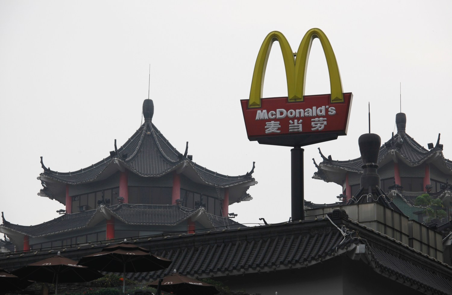 A McDonald's sign is displayed outside its outlet, the first one which opened in China in 1990, at the southern Chinese city of Shenzhen neighbouring Hong Kong March 18, 2013. McDonald's Corp gave away more than a million breakfast McMuffins across China on Monday, a few days after Chinese state television aired its annual expose on corporate malpractice to mark World Consumer Rights Day. The promotion, the U.S. fast food chain says, was purely coincidental. REUTERS/Bobby Yip (CHINA - Tags: FOOD BUSINESS LOGO POLITICS SOCIETY) - RTR3F51T