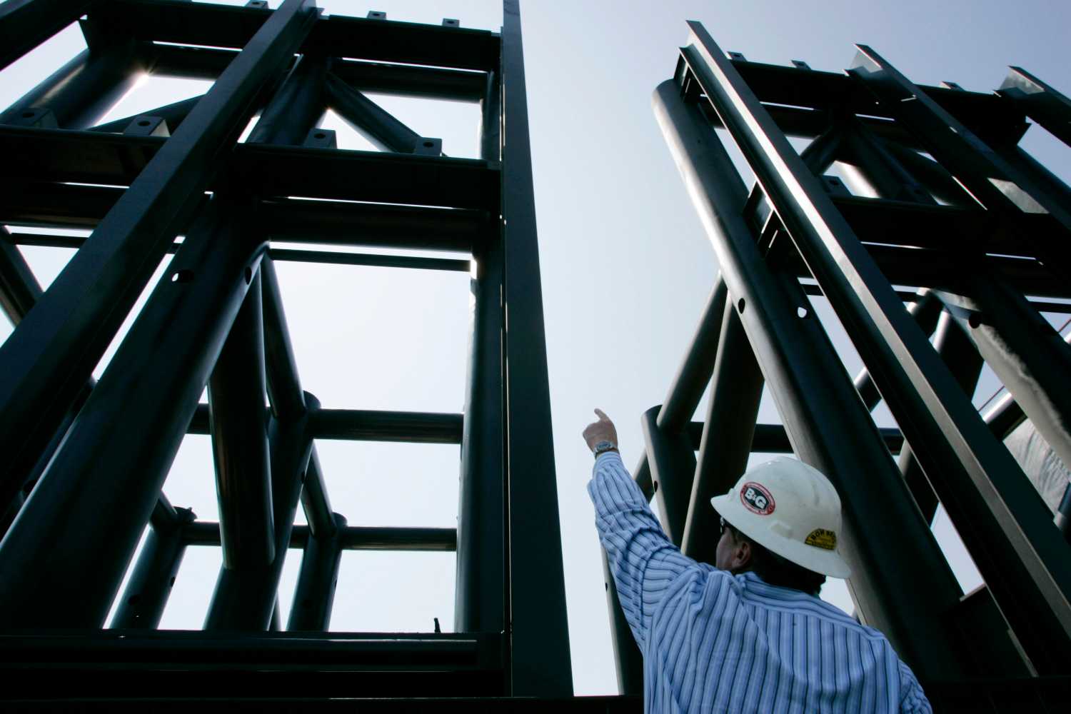 Fred Fuchs, Project Manager of Piling and Marine Projects for the Boh Brothers Company, points out the 17th Street Canal interim gated structure at the fabrication site in New Orleans March 23, 2006. The new floodgate, being built by the Army Corps of Engineers, is designed to keep water below the danger level during the 2006 hurricane season. REUTERS/Lee Celano - RTR17JRO