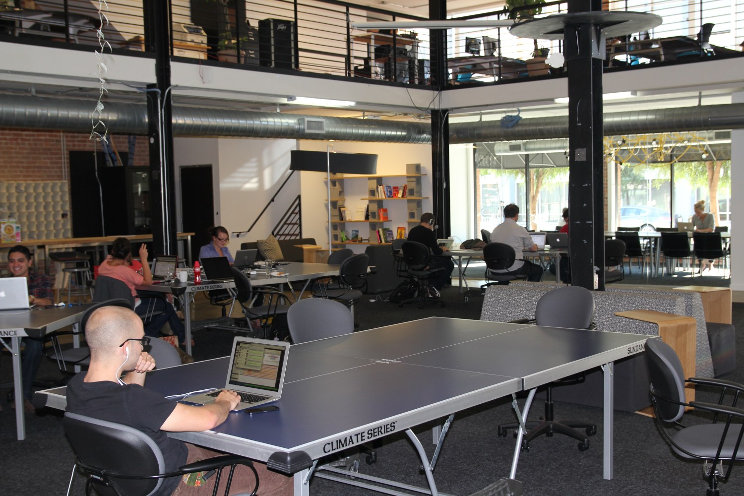 WIKIMEDIA/Msingularian-Open office space with man sitting with a laptop at a ping pong table, October 1, 2012.