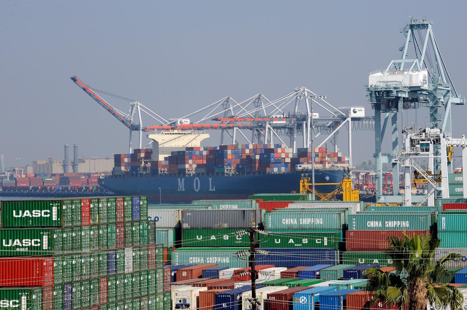 REUTERS/Bob Riha, Jr./File Photo - Cargo containers sit idle at the Port of Los Angeles as a back-log of over 30 container ships sit anchored outside the Port in Los Angeles