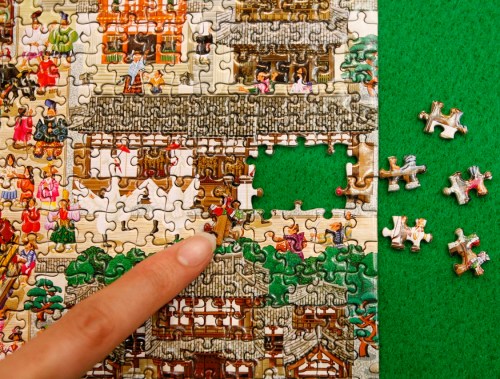 A woman points at the world's smallest 1000-piece puzzle made by Beverly Enterprises Inc. at the International Tokyo Toy Show