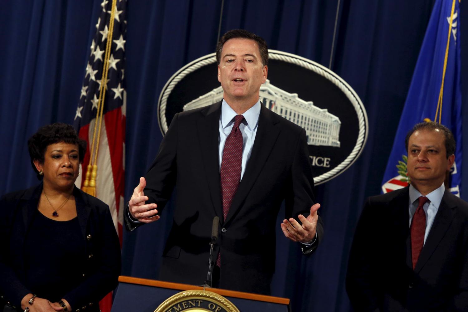 U.S. Attorney General Loretta Lynch (L-R), Federal Bureau of Investigation Director James Comey and Manhattan U.S. Attorney Preet Bharara hold a news conference to announce indictments on Iranian hackers for a coordinated campaign of cyber attacks in 2012 and 2013 on several U.S. banks and a New York dam, at the Justice Department in