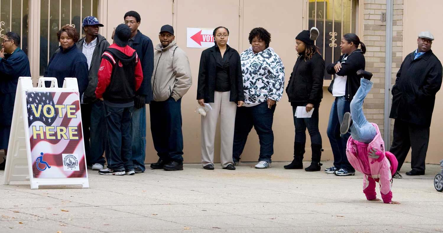 A child plays while voters wait in line at the Martin Luther King Jr. Elementary School in the Anacostia neighborhood of Washington