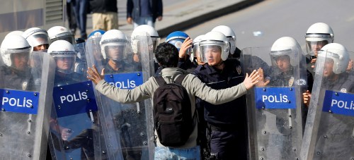 A demonstrator tries to stop riot police as they clash with a crowd gathering to commemorate last year's deadly suicide bombing near the main train station in Ankara, Turkey, October 10, 2016. REUTERS/Umit Bektas TPX IMAGES OF THE DAY TPX IMAGES OF THE DAY - RTSRL6C