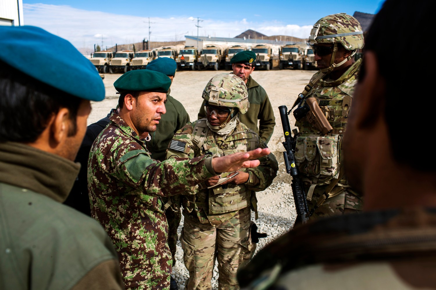 U.S. soldiers from the 3rd Cavalry Regiment speak with Afghan National Army soldiers about their logistics while on an advising mission at the Afghan National Army headquarters for the 203rd Corps in the Paktia province of Afghanistan December 21, 2014. REUTERS/Lucas Jackson (AFGHANISTAN - Tags: CIVIL UNREST POLITICS MILITARY) - RTR4IUML