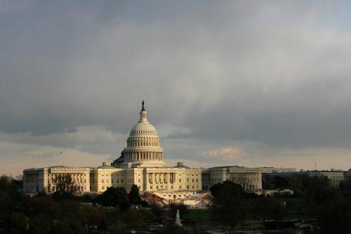 The U.S. Capitol building is seen as the sun begins to set under heavy cloud cover in Washington