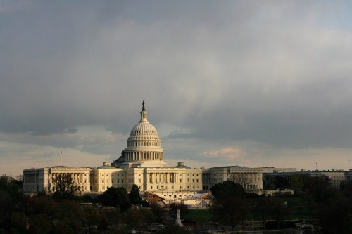 The U.S. Capitol building is seen as the sun begins to set under heavy cloud cover in Washington