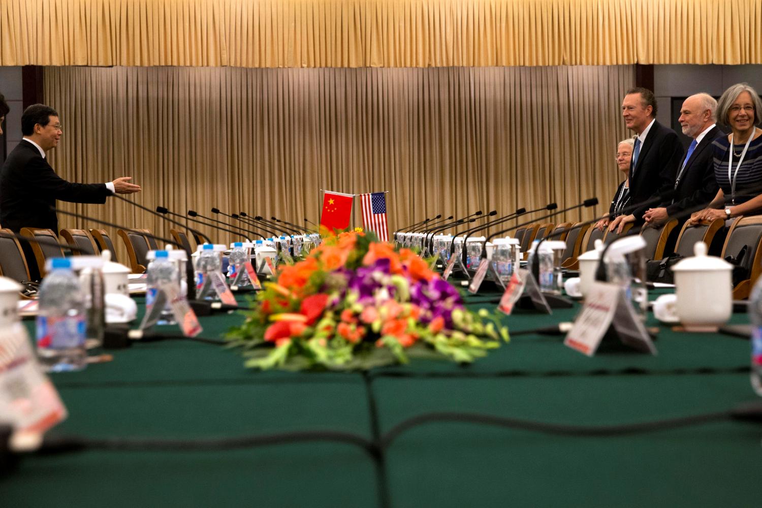 Jiang Wei, vice chairman of the CPC Central Leading Group for Judicial Reform (L) gestures for the U.S. delegation including William Baer, U.S. Principal Deputy Associate Attorney General (2nd, R) to sit before the first China-US judicial dialogue held at the Rui'an hotel in Beijing, China, August 3, 2016. REUTERS/Ng Han Guan/Pool - RTSKSIB