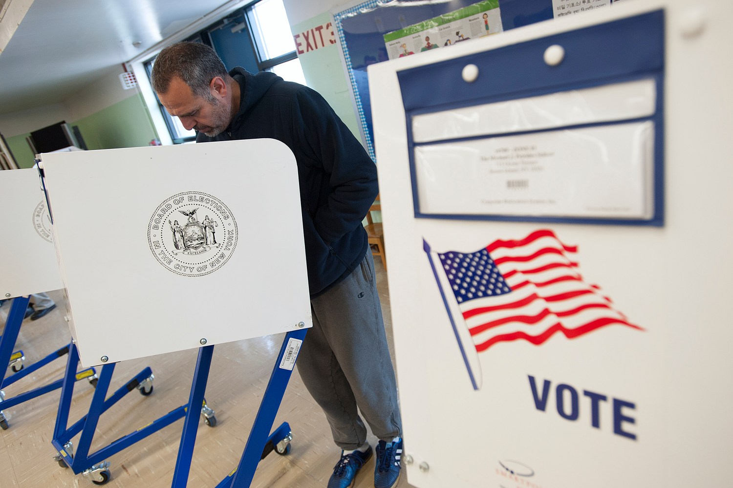 A voter casts his ballot behind a ballot booth during the U.S. presidential election at a polling station in the Staten Island Borough of New York.