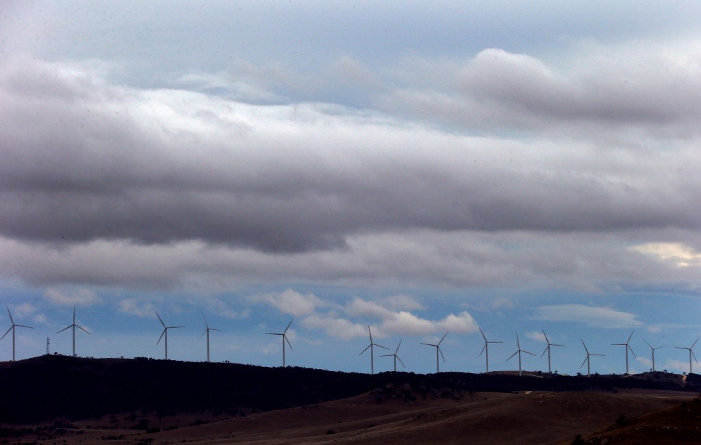 Wind turbines can be seen atop a hill at the Infigen Energy wind farm located on the hills surrounding Lake George, north of the Australian capital city of Canberra May 13, 2013.
