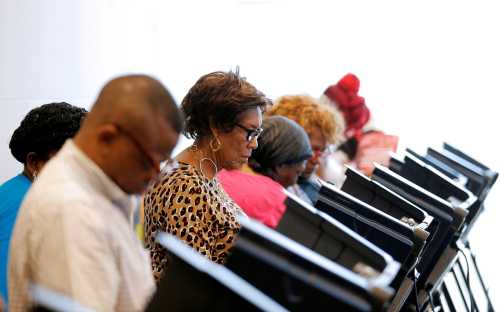 Voters cast their ballots during early voting at the Beatties Ford Library in Charlotte, North Carolina, U.S. on October 20, 2016. To match Insight USA-ELECTION/NORTHCAROLINA REUTERS/Chris Keane/File Photo - RTX2ROEQ