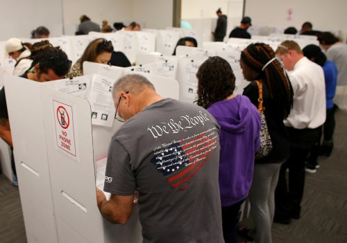A voter wears a shirt with words from the United States Constitution while casting his ballot early as long lines of voters vote at the San Diego County Elections Office in San Diego, California, U.S., November 7, 2016. REUTERS/Mike Blake TPX IMAGES OF THE DAY - RTX2SDO4