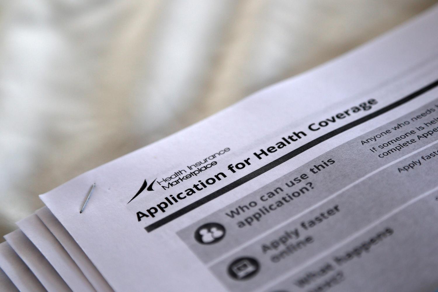 The federal government forms for applying for health coverage are seen at a rally held by supporters of the Affordable Care Act, widely referred to as "Obamacare", outside the Jackson-Hinds Comprehensive Health Center in Jackson, Mississippi, U.S. on October 4, 2013. REUTERS/Jonathan Bachman/File Photo - RTSO349