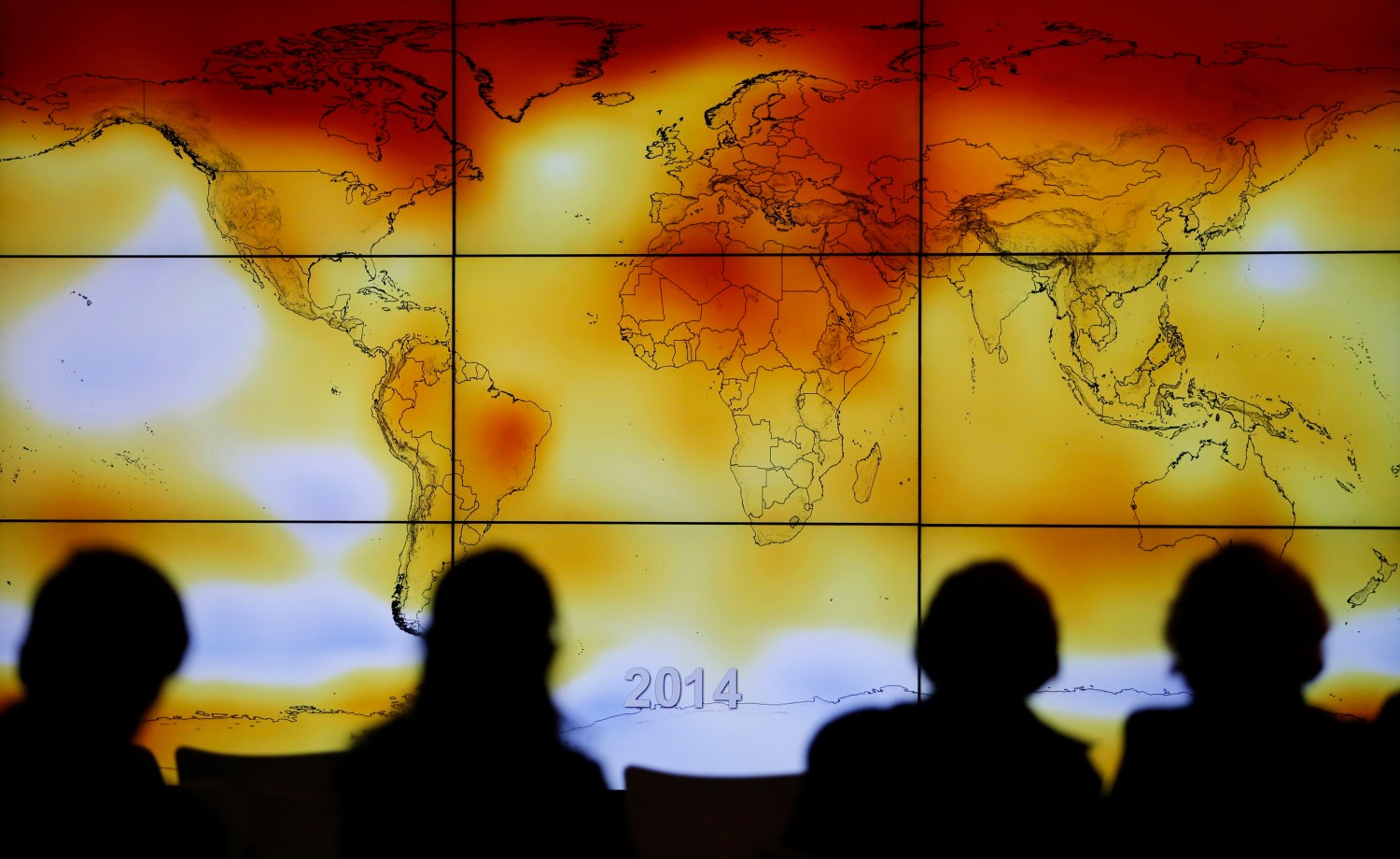 Participants are seen in silhouette as they look at a screen showing a world map with climate anomalies during the World Climate Change Conference 2015 (COP21) at Le Bourget, near Paris, France, December 8, 2015. REUTERS/Stephane Mahe TPX IMAGES OF THE DAY - RTX1XPHY