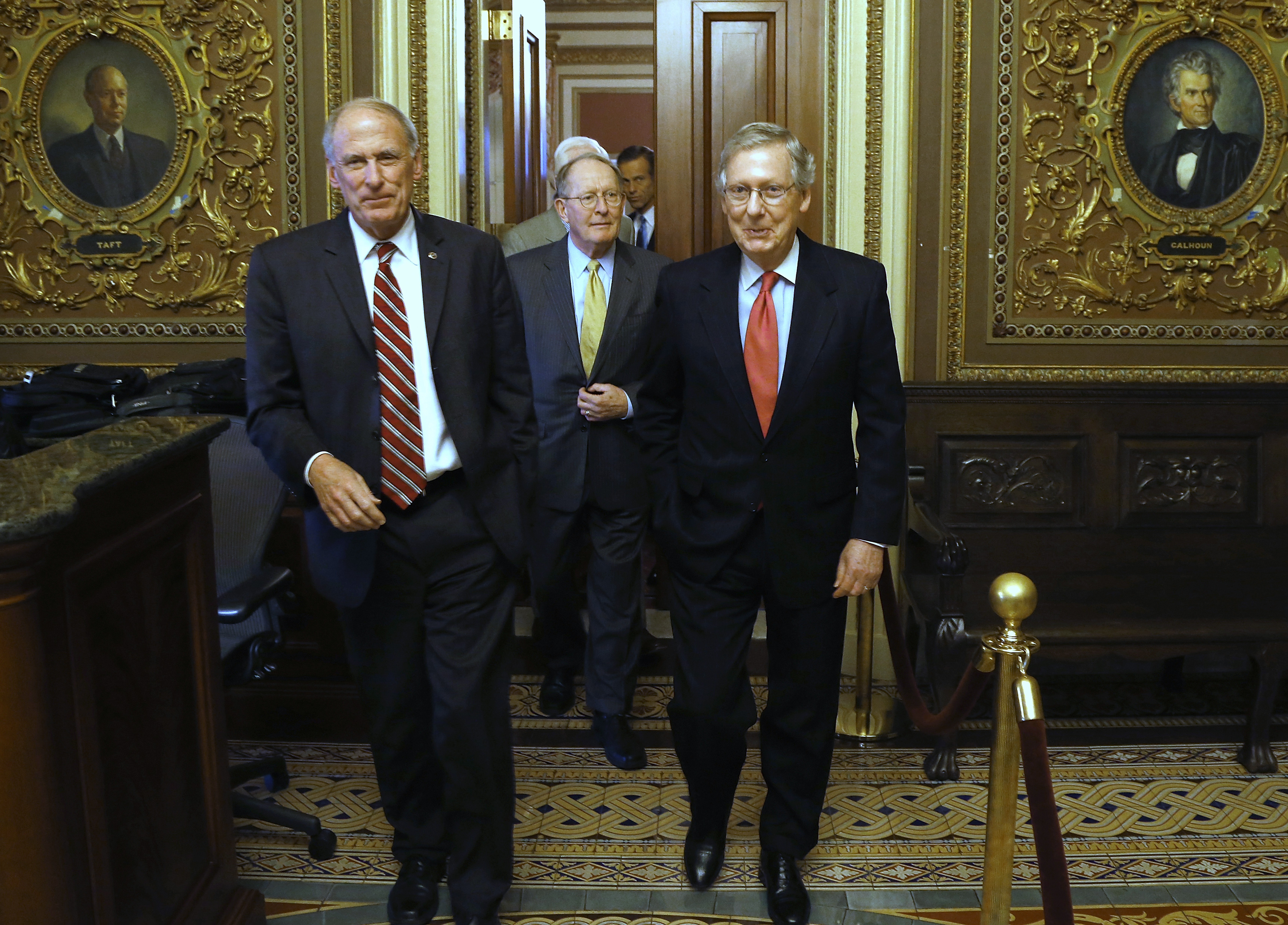 U.S. Senator Dan Coats (R-IN) (L-R), Senator Lamar Alexander (R-TN) and Senate Minority Leader Mitch McConnell (R-KY) depart following their weekly Republican caucus lunch meeting