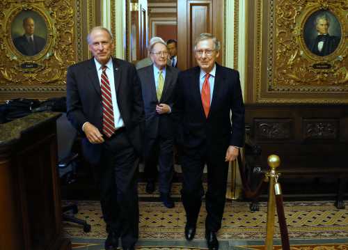 U.S. Senator Dan Coats (R-IN) (L-R), Senator Lamar Alexander (R-TN) and Senate Minority Leader Mitch McConnell (R-KY) depart following their weekly Republican caucus lunch meeting
