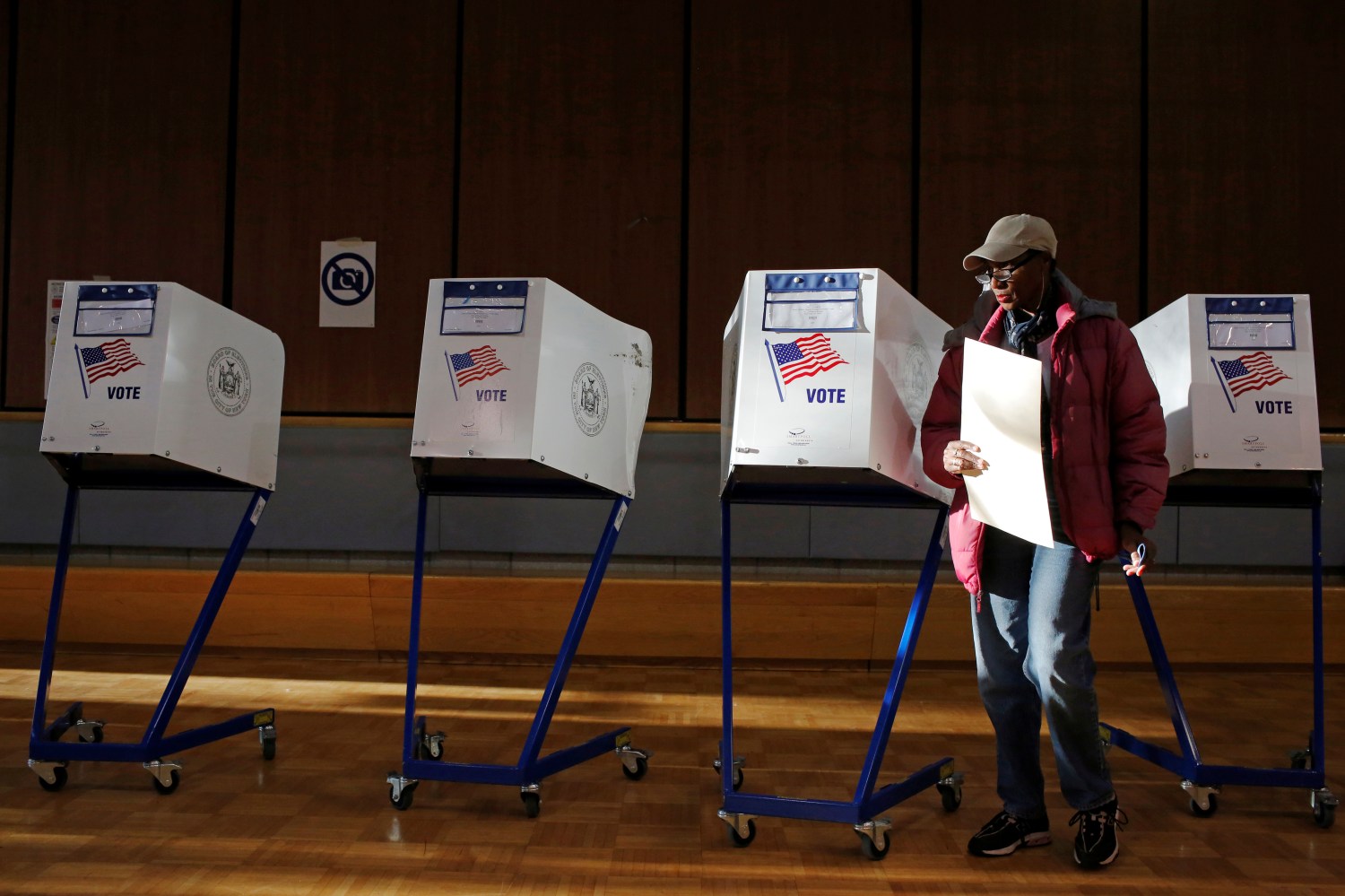 A woman exits the voting booth after filling out her ballot for the U.S presidential election at the James Weldon Johnson Community Center in the East Harlem neighbourhood of Manhattan, New York City, U.S. November 8, 2016. REUTERS/Andrew Kelly - RTX2SIHQ