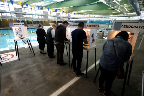 People vote on the deck of the Echo Park Deep Pool during the U.S. Presidential Primary Election in Los Angeles, California U.S., June 7, 2016. REUTERS/Mario Anzuoni - RTSGFRU