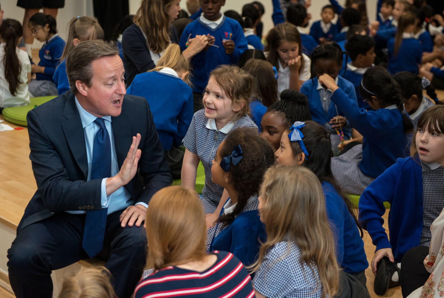 Britain's Prime Minister David Cameron speaks to children during a visit to Reach Academy Feltham, in south west London
