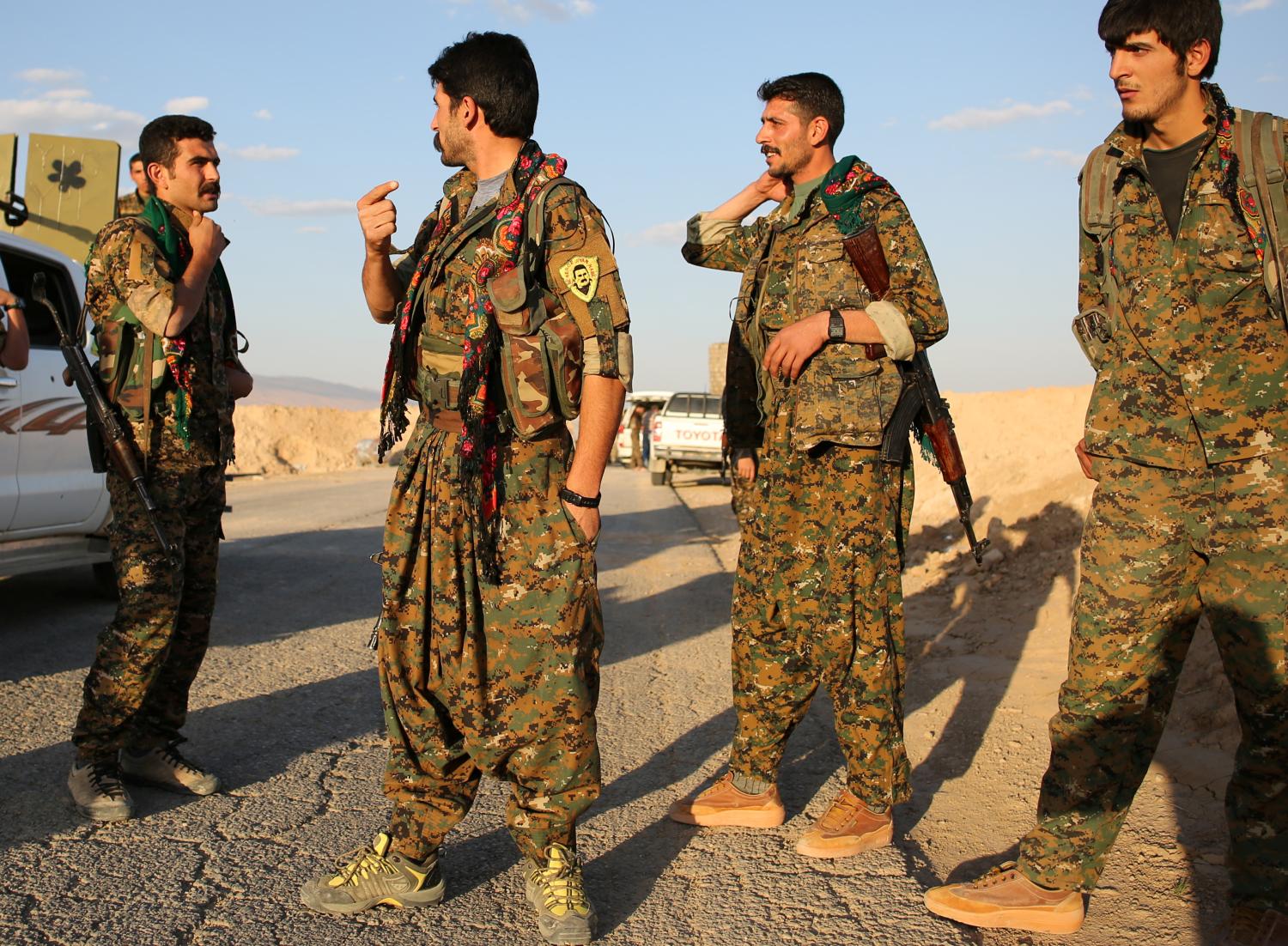 Members of the Sinjar Resistance Units (YBS), a militia affiliated with the Kurdistan WorkersÕ Party (PKK), stand in the village of Umm al-Dhiban, northern Iraq, April 29, 2016. They share little more than an enemy and struggle to communicate on the battlefield, but together two relatively obscure groups have opened up a new front against Islamic State militants in a remote corner of Iraq. The unlikely alliance between the Sinjar Resistance Units, an offshoot of a leftist Kurdish organisation, and Abdulkhaleq al-Jarba, a Arab tribal militia is a measure of the extent to which Islamic State has upended the regional order. Across Iraq and Syria, new groups have emerged where old powers have waned, competing to claim fragments of territory from Islamic State and complicating the outlook when they win. REUTERS/Goran Tomasevic SEARCH "YBS TOMASEVIC" FOR THIS STORY. SEARCH "THE WIDER IMAGE" FOR ALL STORIES - RTX2DRRU