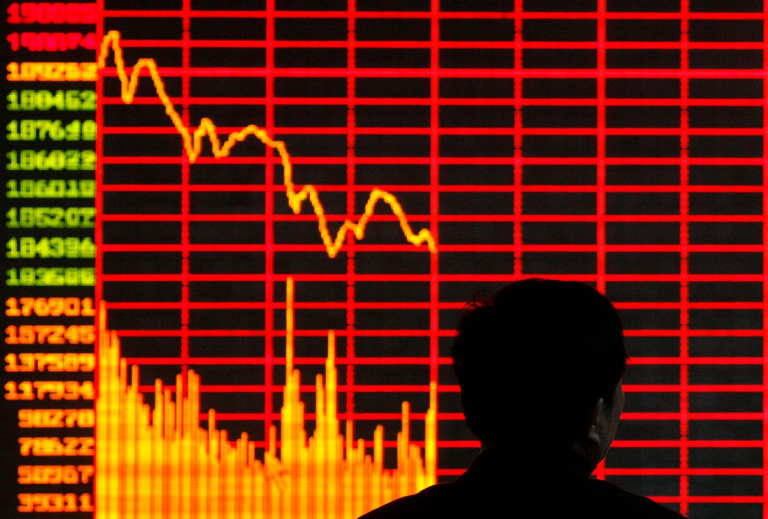 An investor is seen in front of an electronic board showing stock information at a brokerage house in Taiyuan, Shanxi province February 12, 2009. Chinese stocks slid in heavy trade on Thursday as profit-taking increased after the main index jumped 24 percent this year on hopes for an early economic recovery. REUTERS/Stringer (CHINA). CHINA OUT. NO COMMERCIAL OR EDITORIAL SALES IN CHINA. - RTXBIZ9