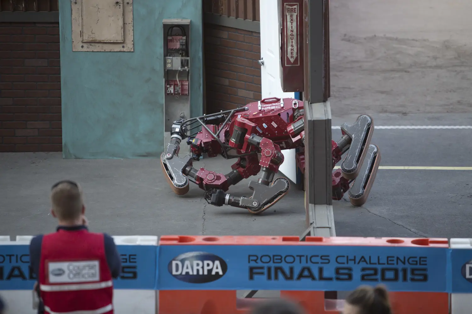The Tartan Rescue team CHIMP (CMU Highly Intelligent Mobile Platform) robot falls down while trying to go through a doorway on a simulated disaster-response course on day one of the DARPA (Defense Advanced Research Projects Agency) Robotics Challenge finals in Pomona, California