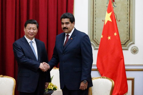 China's President Xi Jinping (L) shakes hands with Venezuela's President Nicolas Maduro at a meeting in Miraflores Palace in Caracas July 20, 2014. REUTERS/Jorge Silva (VENEZUELA - Tags: POLITICS) - RTR3ZG6I