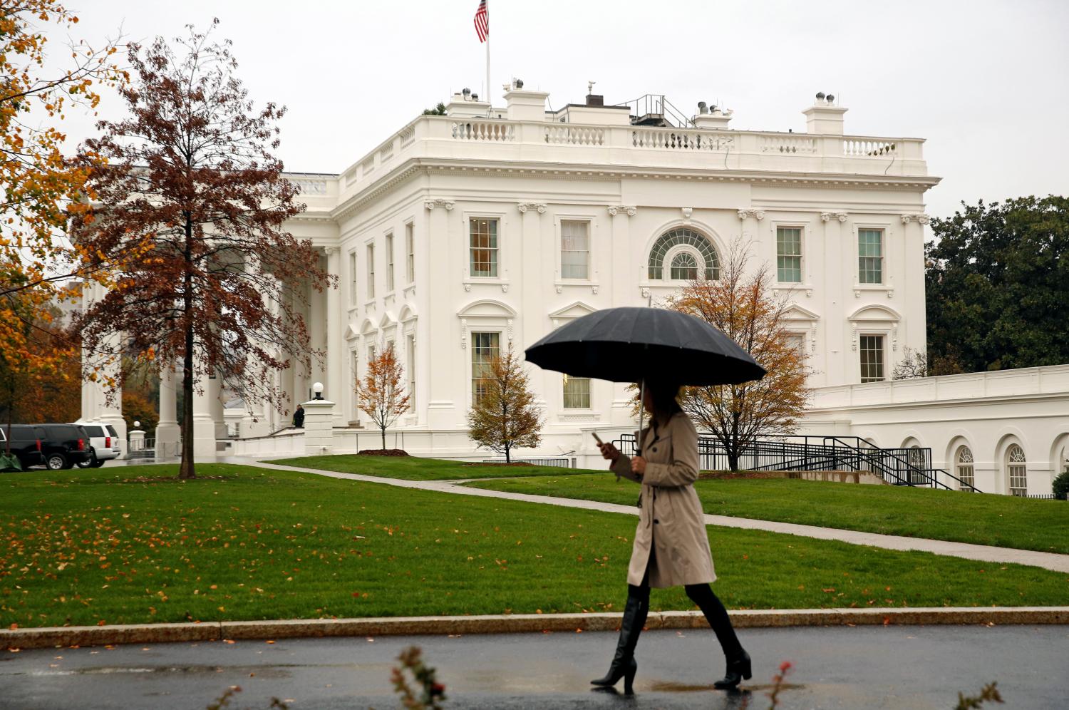 Woman holds an umbrella at the White House in Washington