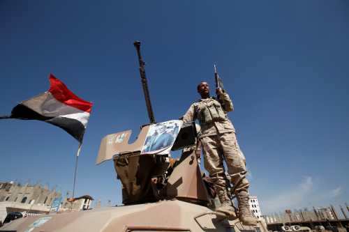 A pro-Houthi soldier stands on a military armoured personnel carrier next to a poster of Yemen's former President Ali Abdullah Saleh during a tribal gathering held to mobilize fighters for battles against government forces, in Sanaa, Yemen November 24, 2016. REUTERS/Khaled Abdullah - RTST35J