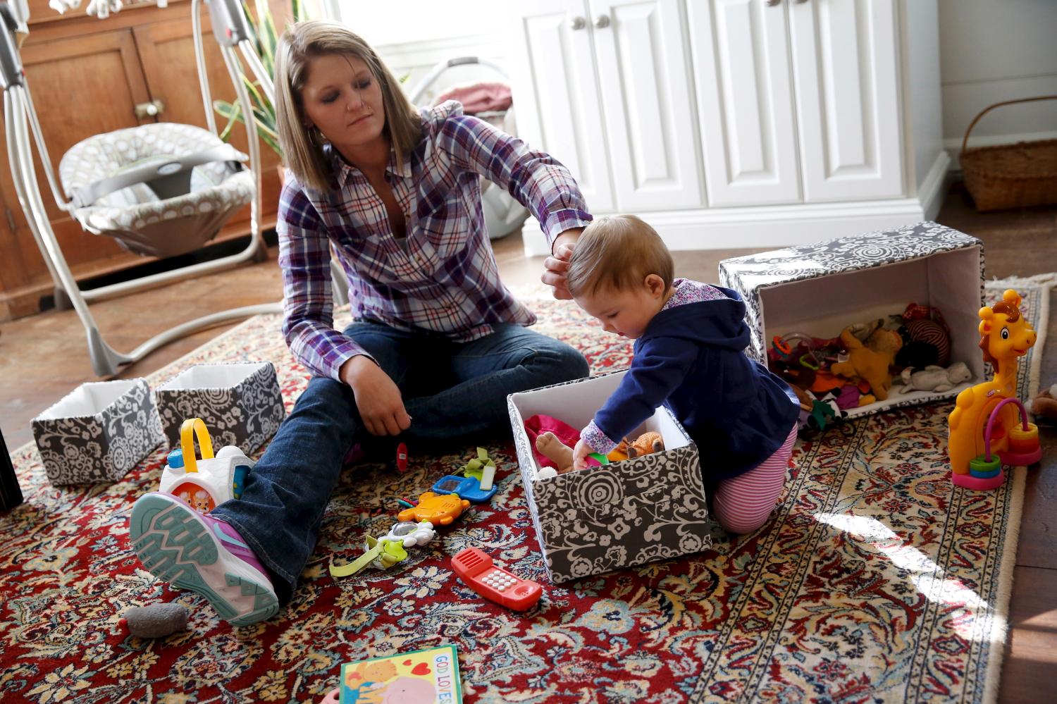 Katy Gooding plays with her baby.