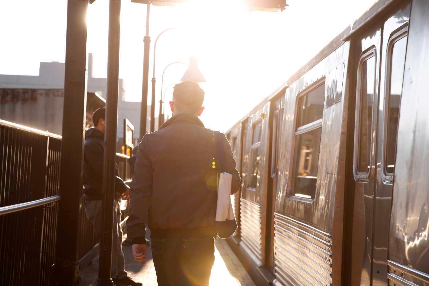 A commuter walks to board a subway train in the Brooklyn borough of New York City.