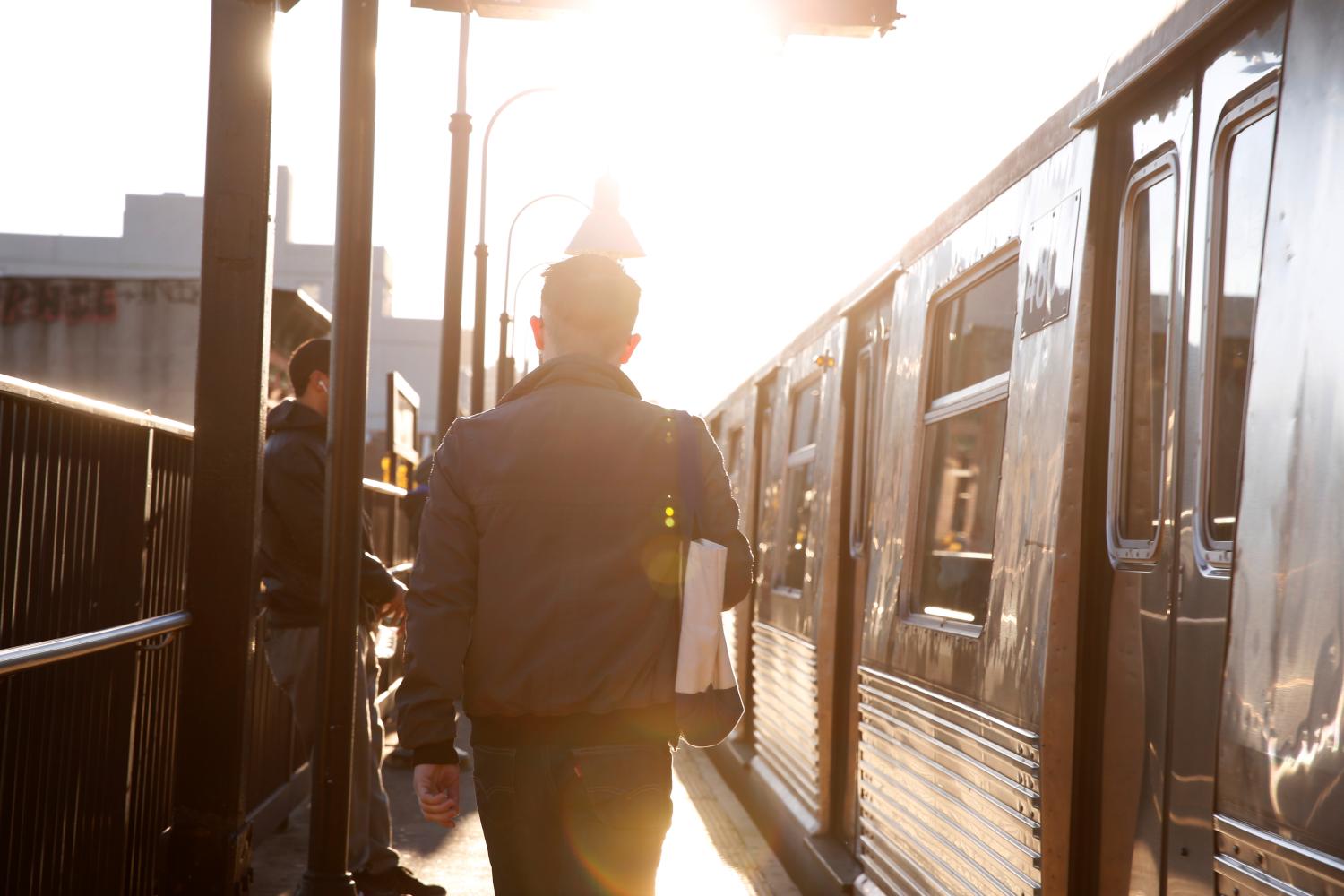 A commuter walks to board a subway train in the Brooklyn borough of New York City.