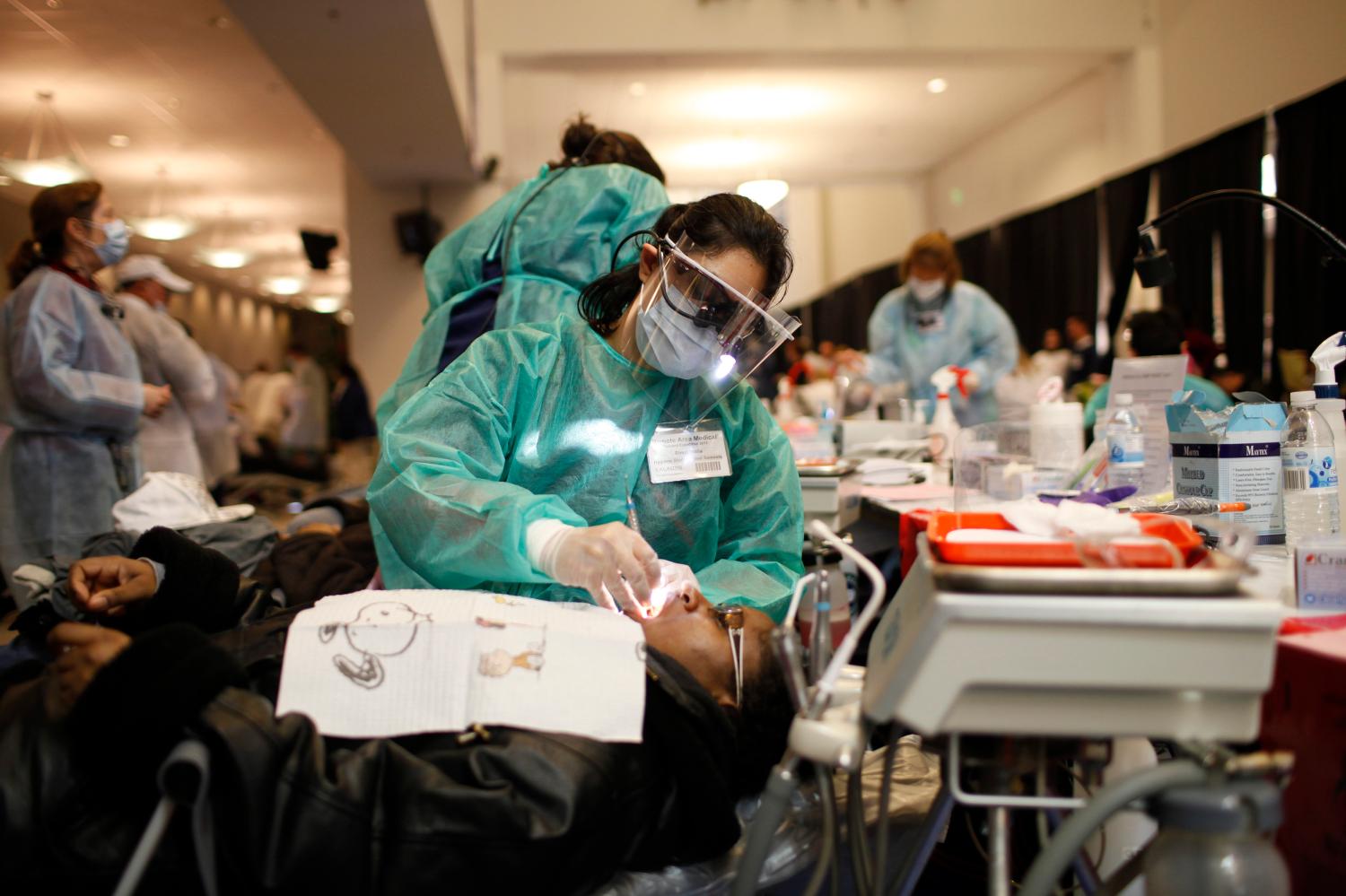 Dental hygiene student Rimpi Walia performs a procedure on a patient